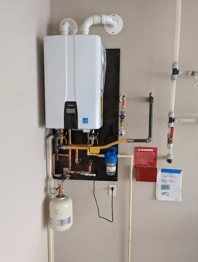 Professional plumber installing copper piping in a Edgewood home